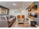 Spacious living room with stylish gray sofa, orange chairs, and unique wall decor at 1421 Wexford Way, Davenport, FL 33896