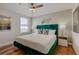Stylish bedroom features a luxe green velvet headboard and hardwood flooring at 1421 Wexford Way, Davenport, FL 33896
