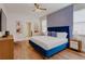 Stylish main bedroom boasts an accent wall, wood floors, and comfortable furnishings at 1421 Wexford Way, Davenport, FL 33896