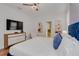 Bright main bedroom featuring wood floors, contemporary decor, and bathroom access at 1421 Wexford Way, Davenport, FL 33896