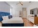 Well-lit main bedroom with an accent wall, wood-look flooring and modern decor at 1421 Wexford Way, Davenport, FL 33896