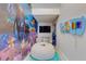 Fun playroom featuring colorful wall art, soft seating, and a wall-mounted xylophone at 1421 Wexford Way, Davenport, FL 33896