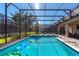 Relaxing screened-in pool area with clear blue water and a lovely yard at 1421 Wexford Way, Davenport, FL 33896