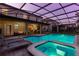 Inviting pool area with a connected spa, screened in for comfort, surrounded by lounge chairs at 1421 Wexford Way, Davenport, FL 33896