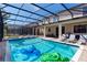 Screened-in pool with lounge chairs and spa, perfect for outdoor relaxation and entertainment at 1421 Wexford Way, Davenport, FL 33896