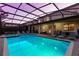 Sparkling screened-in pool with lounge chairs and covered patio, perfect for outdoor entertaining at 1421 Wexford Way, Davenport, FL 33896