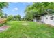 Lush, green backyard featuring a well-maintained lawn and a privacy fence at 147 Country Club Dr, Sanford, FL 32771