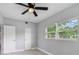 Bedroom featuring ceiling fan, neutral paint, and a large window with blinds at 147 Country Club Dr, Sanford, FL 32771
