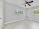 Bedroom featuring neutral paint, base trim, and dual windows providing ample natural light at 147 Country Club Dr, Sanford, FL 32771
