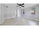 Bedroom featuring modern ceiling fan, neutral paint, and easy access to ensuite bath at 147 Country Club Dr, Sanford, FL 32771