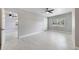 Spacious bedroom featuring modern ceiling fan, natural lighting, and light wood-look tile at 147 Country Club Dr, Sanford, FL 32771