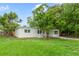 Single story home with a freshly mowed front lawn, recently painted exterior, and mature trees at 147 Country Club Dr, Sanford, FL 32771