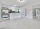 Modern kitchen with stainless steel appliances, white cabinets, and a sleek kitchen island at 147 Country Club Dr, Sanford, FL 32771