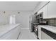 Bright, modern kitchen with stone countertops, stainless steel appliances, and ample cabinet space at 147 Country Club Dr, Sanford, FL 32771