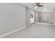 Large living area with wood-look tile floors, lots of natural light and high ceilings at 147 Country Club Dr, Sanford, FL 32771