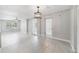 Open living room featuring light gray paint, modern light fixture, and sleek tile flooring at 147 Country Club Dr, Sanford, FL 32771