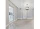 Spacious, light-filled room with modern light fixture, and access to multiple rooms and closets at 147 Country Club Dr, Sanford, FL 32771