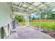 Covered patio with white support columns and a view of the spacious backyard at 147 Country Club Dr, Sanford, FL 32771