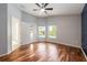 Spacious bedroom with hardwood floors, ceiling fan, natural light, and access to a private patio at 15309 Markham Dr, Clermont, FL 34714