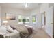 Bright bedroom with a comfortable bed, a large window, and an en-suite bathroom, with a relaxing atmosphere at 15309 Markham Dr, Clermont, FL 34714
