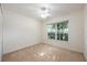 Simple bedroom with neutral carpet, closet, and bright light from large window at 15309 Markham Dr, Clermont, FL 34714