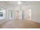 Spacious bedroom with natural light and multiple doorways leading to other areas of the house at 15309 Markham Dr, Clermont, FL 34714