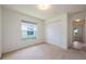 Simple bedroom with neutral carpet, closet, and single window at 15309 Markham Dr, Clermont, FL 34714