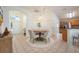 Open dining area with a round wooden table and four chairs, with easy access to the kitchen and living room at 15309 Markham Dr, Clermont, FL 34714