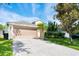 Charming single Gathering home with a two car garage and landscaped front yard, with mature trees in a well maintained area at 15309 Markham Dr, Clermont, FL 34714