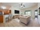 Cozy living room with tiled floors, a ceiling fan, and sliding glass doors leading to the outdoor patio at 15309 Markham Dr, Clermont, FL 34714