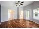 Large main bedroom with private entry to bathroom and backyard; features wood flooring and natural light at 15309 Markham Dr, Clermont, FL 34714