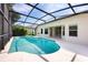 Inviting screened-in pool featuring a clear blue water and a spacious patio area at 15309 Markham Dr, Clermont, FL 34714