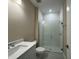 Bathroom featuring modern fixtures, a sleek vanity, and a glass-enclosed shower at 15569 Orchid Rose Ct, Winter Garden, FL 34787
