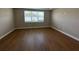 Serene bedroom featuring hardwood floors and a window at 15569 Orchid Rose Ct, Winter Garden, FL 34787
