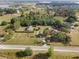 Expansive aerial view of the property featuring multiple buildings, open land, and fencing for added privacy at 16017 Johns Lake Rd, Clermont, FL 34711