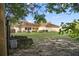 A spacious backyard featuring a well-maintained lawn, landscaping, and screened-in porch at 16017 Johns Lake Rd, Clermont, FL 34711