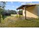 Backyard view with covered patio and lush greenery at 16017 Johns Lake Rd, Clermont, FL 34711