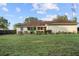 A spacious backyard featuring a well-maintained lawn, landscaping, and fence line at 16017 Johns Lake Rd, Clermont, FL 34711