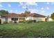 Expansive backyard view showcasing home's exterior and well-maintained lawn at 16017 Johns Lake Rd, Clermont, FL 34711