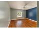 Bedroom with hardwood floors, a window, and a ceiling fan at 16017 Johns Lake Rd, Clermont, FL 34711