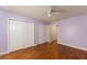 Bedroom with hardwood floor, ceiling fan, and closet at 16017 Johns Lake Rd, Clermont, FL 34711