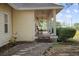 A cozy front porch with a ceiling fan and a chair, perfect for relaxing and enjoying the outdoors at 16017 Johns Lake Rd, Clermont, FL 34711