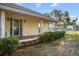 Charming home featuring a covered front porch, lush landscaping, and a well-maintained exterior at 16017 Johns Lake Rd, Clermont, FL 34711