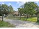 A charming single-story home with a large yard and a gated driveway, blending rural serenity at 16017 Johns Lake Rd, Clermont, FL 34711