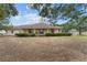 Charming home with covered porch, surrounded by green shrubs at 16017 Johns Lake Rd, Clermont, FL 34711