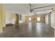Spacious garage featuring garage door, storage racks, utility connections, and natural light at 16017 Johns Lake Rd, Clermont, FL 34711