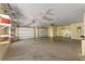 Garage featuring two garage doors, a utility sink, and plenty of storage at 16017 Johns Lake Rd, Clermont, FL 34711
