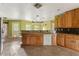 Spacious kitchen with tile floors, wooden cabinets, and stainless steel appliances at 16017 Johns Lake Rd, Clermont, FL 34711
