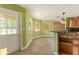 Kitchen area featuring tile floors, wooden cabinets, and a breakfast bar at 16017 Johns Lake Rd, Clermont, FL 34711
