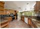 Well-lit kitchen featuring tile floors, wood cabinets, and stainless steel appliances at 16017 Johns Lake Rd, Clermont, FL 34711